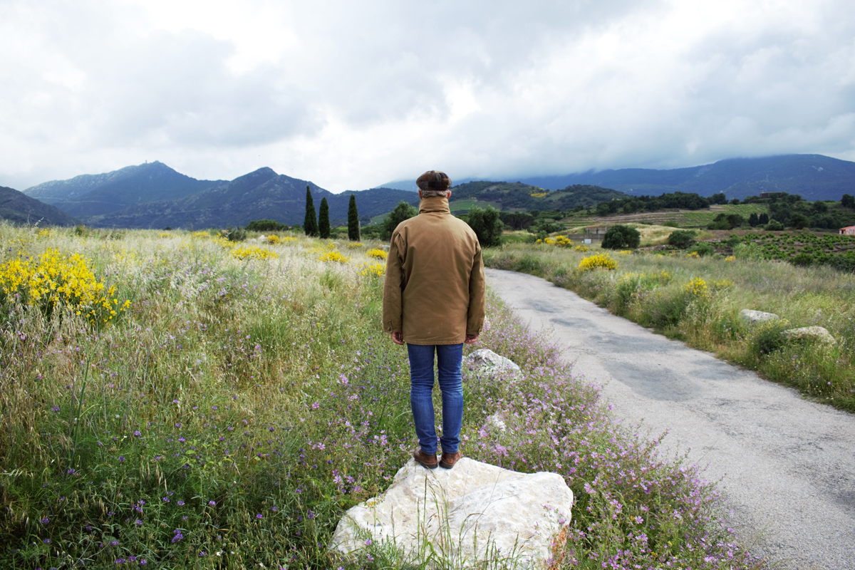 man standing on a rock watching the horizon